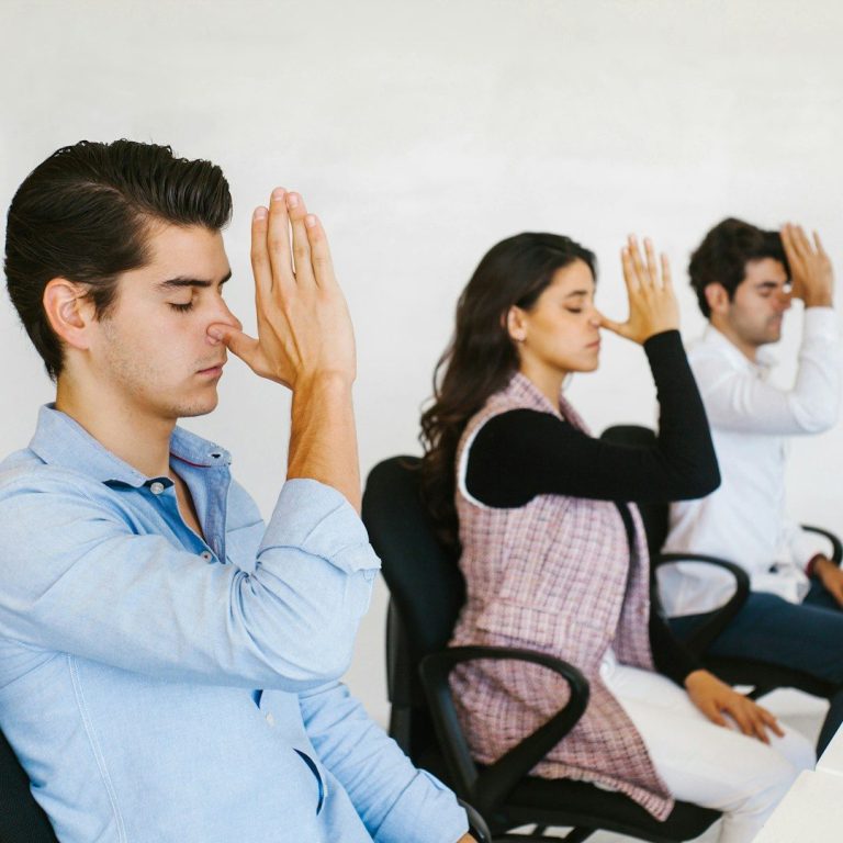 workplace-wellbeing-breathwork-seated People practising breathwork in workplace